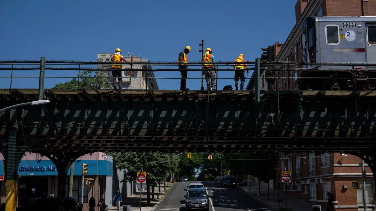 Workers repair a subway train platform in the Bronx on July 11, 2024