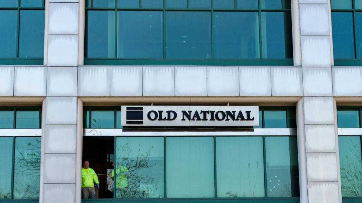 Workers replace a window with bullet holes after a mass shooting at the Old National Bank on April 11, 2023 at Metro Hall in Louisville, Kentucky. On the morning of April 10, a gunman opened fire inside the bank killing four people. A fifth victim later died in the hospital.