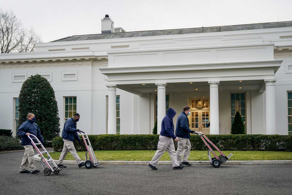 Workers roll dollies past the West Wing of the White House on January 15, 2021 in Washington, DC. According to recent news reports, President Donald Trump is slated to leave Washington the morning of Jan. 20th, hours before President-elect Joe Biden will be sworn-in as president.