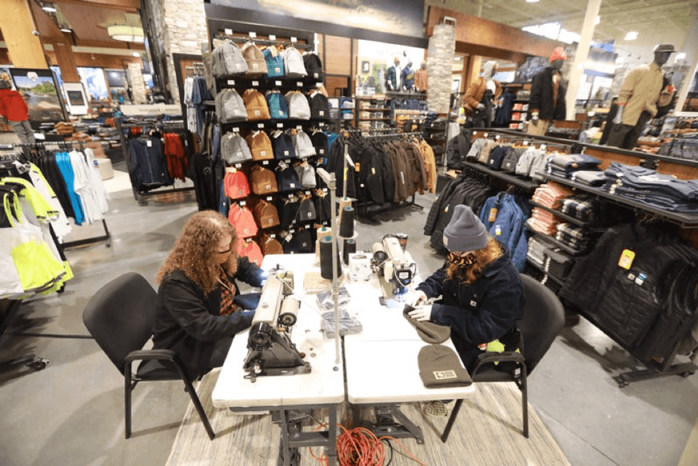 Workers sewing at a Carhartt store