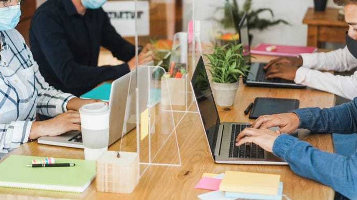 Workspace with plexiglass dividers to protect from COVID-19.