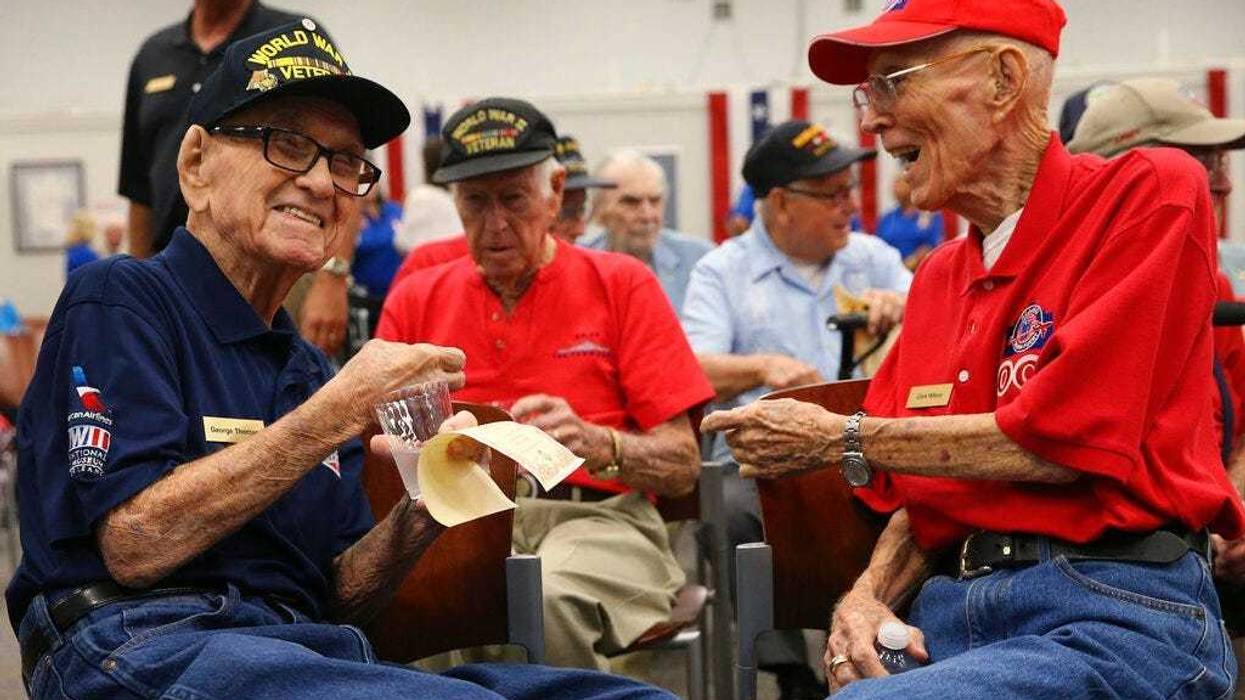 World War II veterans George Thomas, 97, left, and Clark Wilson, 93, enjoy conversation before a ceremony