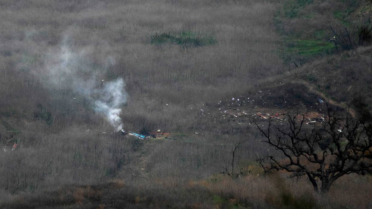 Wreckage of the crashed helicopter that was carrying former NBA star Kobe Bryant and his 13-year-old daughter Gianna smolders on the ground on January 26, 2020 in Calabasas, California.