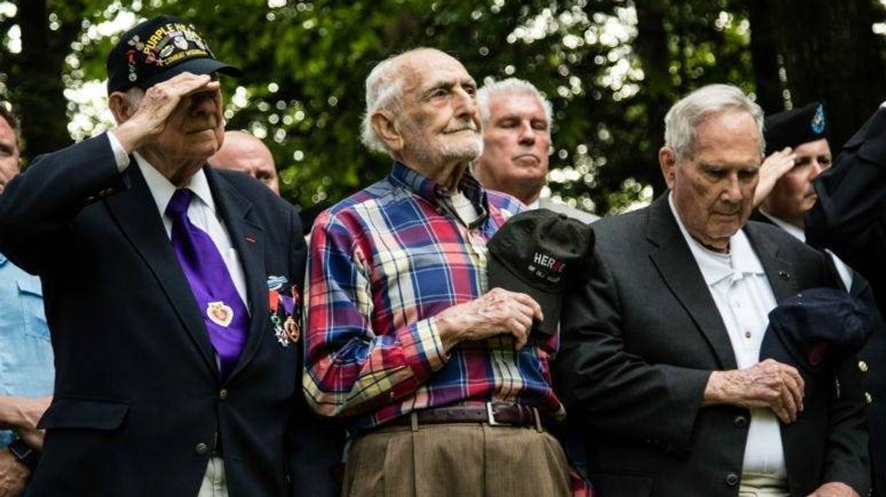 WWII veterans pay respect to the U.S. flag at the 30th ID Old Hickory memorial ceremony on June 2 at Mortain, France.