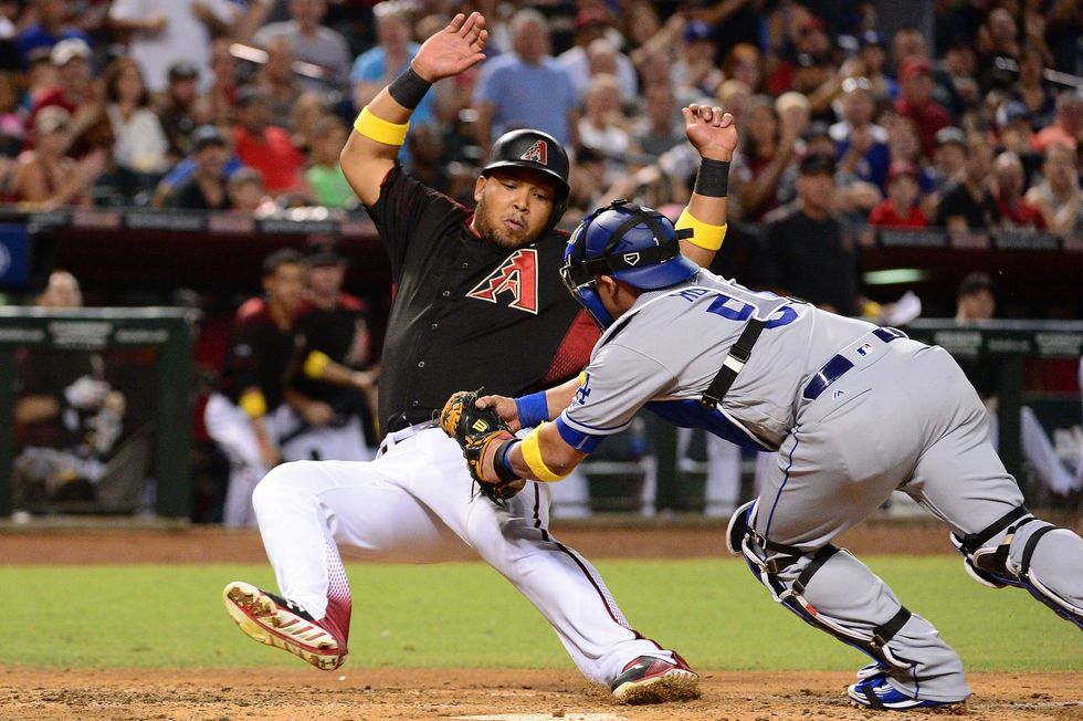 Yasmany Tomas tries to avoid a tag at home plate