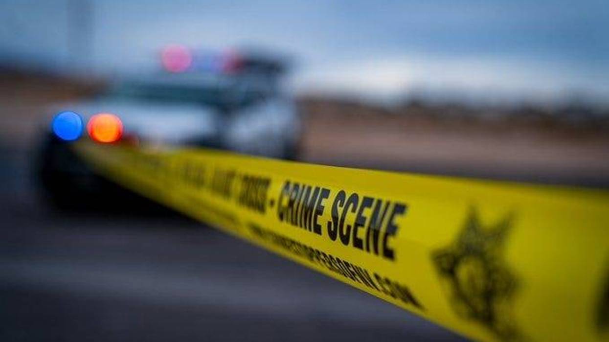 Yellow tape surrounds a crime scene investigation