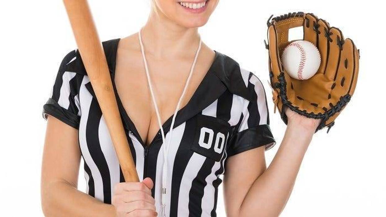 Young Beautiful Referee Wearing Baseball Glove And Holding Baseball Bat