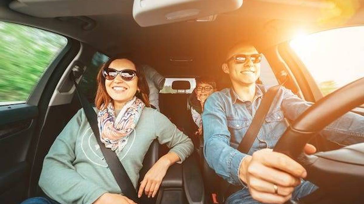 Young family in a car on a road trip