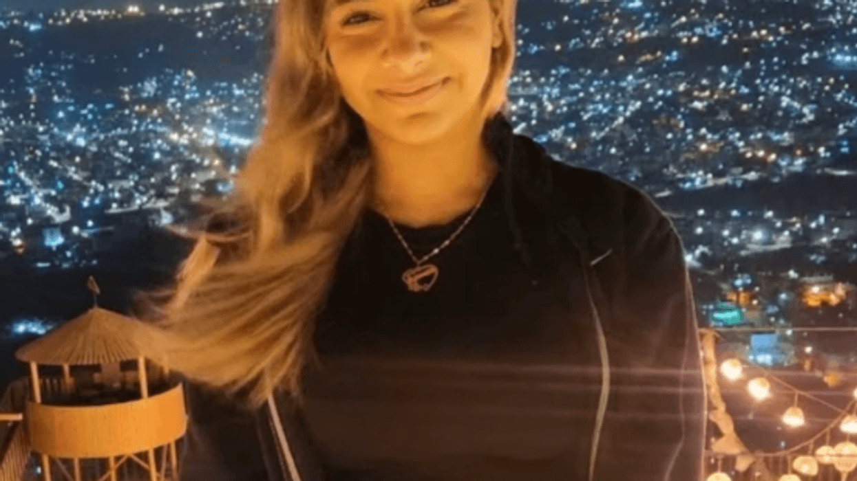 Young girl in front of bright city lights
