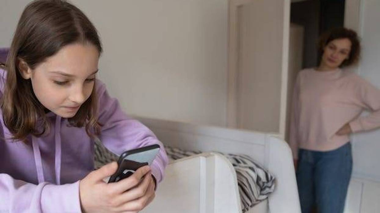 Young girl on phone ignoring her mom