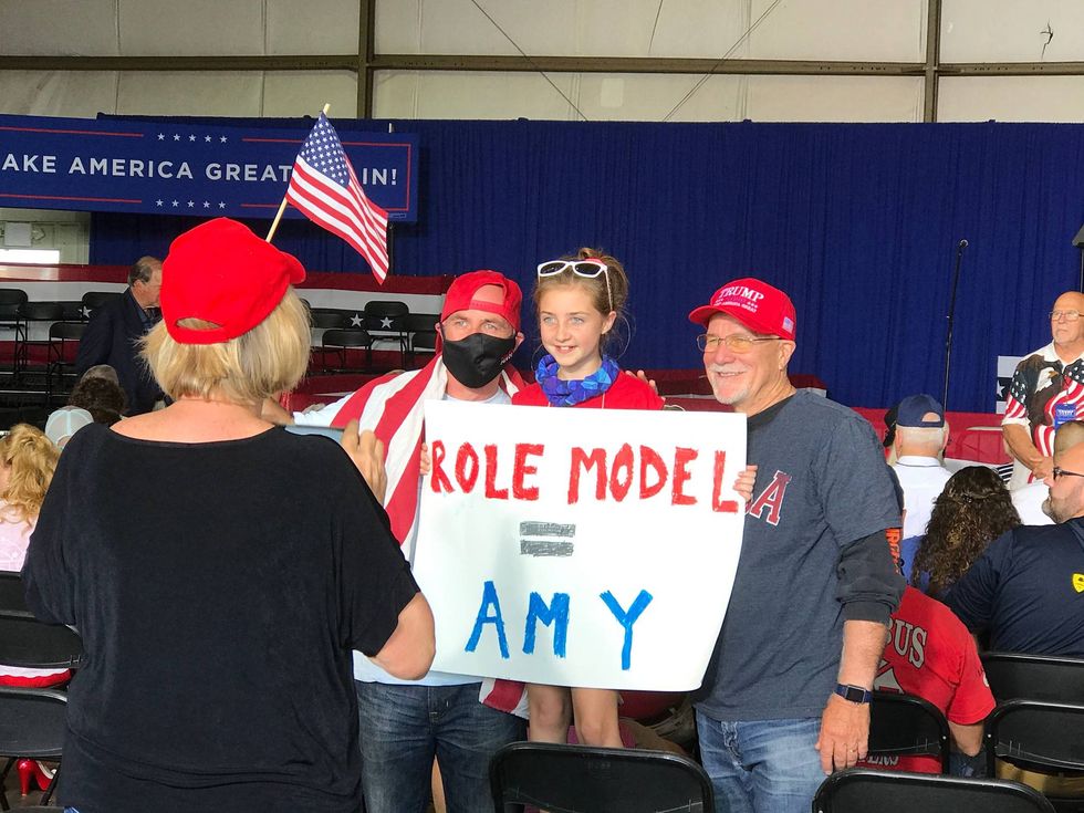 Young girl poses with sign about Amy Coney Barrett