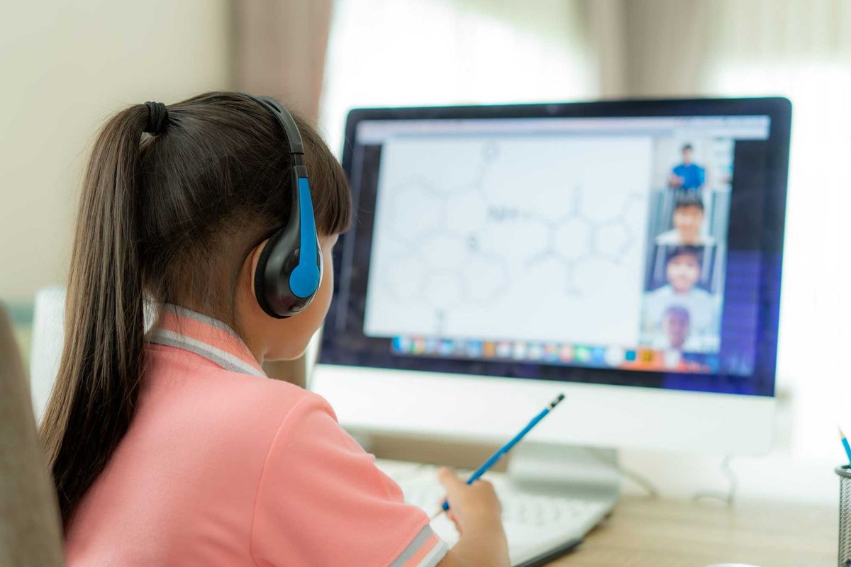 young girl remote learning at home computer