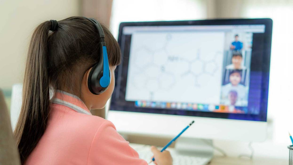young girl remote learning at home computer