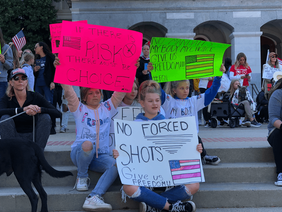 Young girls hold signs at the California State Capitol on Monday.