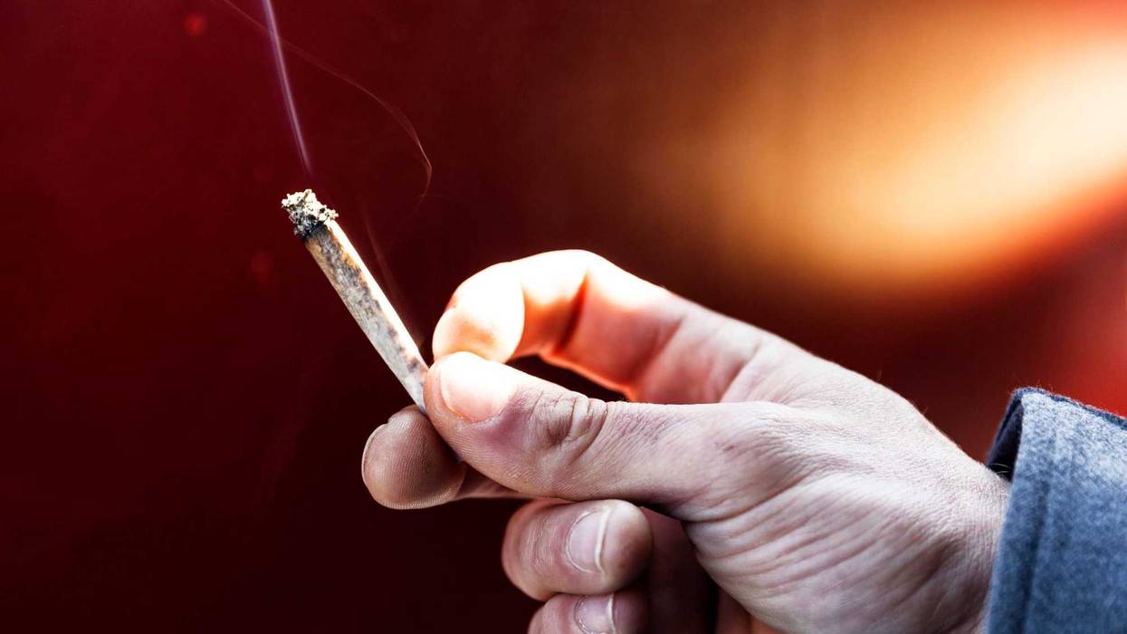 Young man smoking a joint.