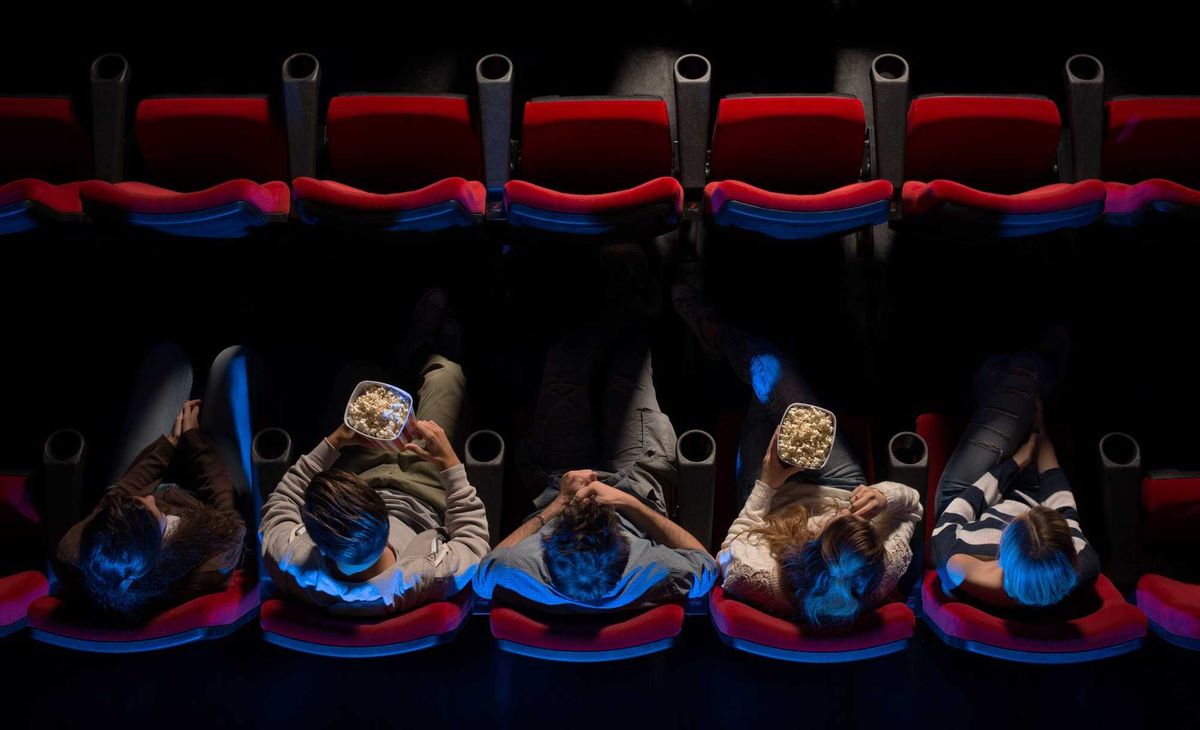 Young people sitting at the cinema.