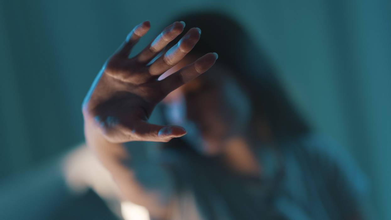 Young woman doing a stop sign with her hand