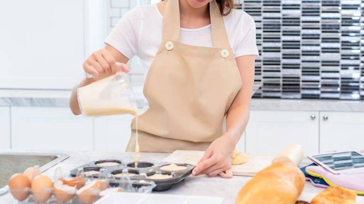 Young woman pouring batter