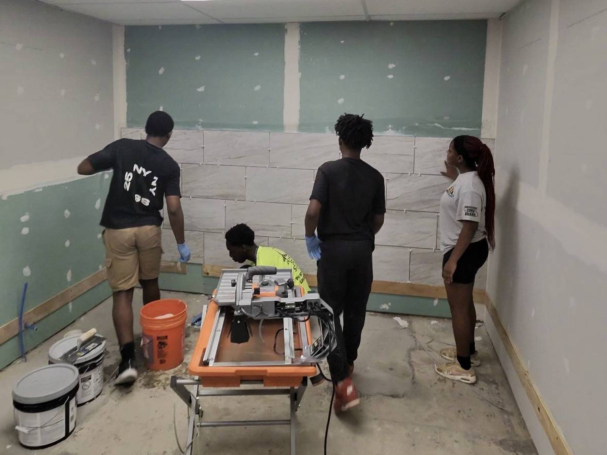 Youth builders working on a bathroom in Martin's Temple.
