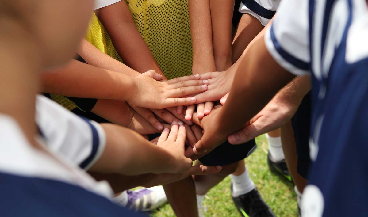 Youth soccer teammates huddling up