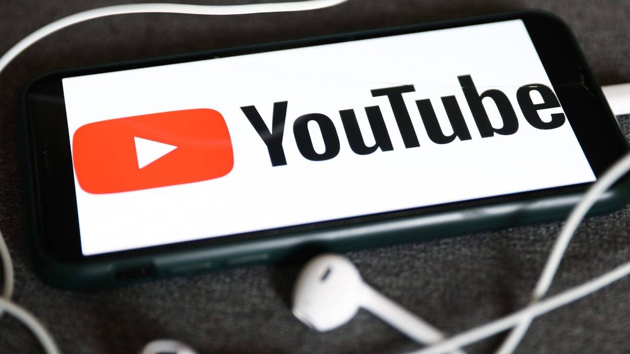 YouTube logo displayed on a phone and headphones