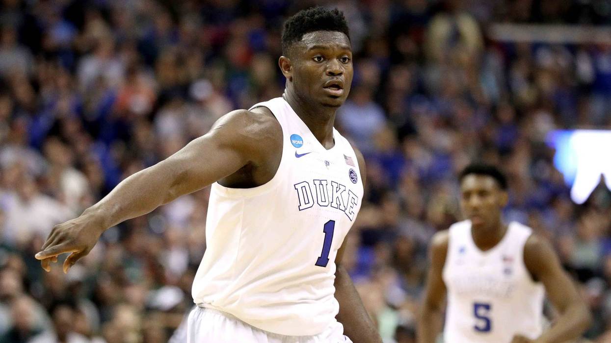 Zion Williamson points on defense during a game at Duke.